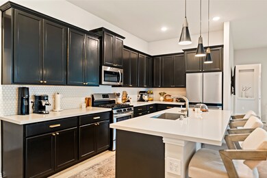 This modern kitchen features rich dark wood cabine