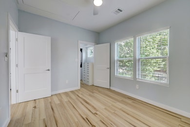The vinyl plank floors continue into the bedroom which has a ceiling fan, views to the front, and closet with laundry.