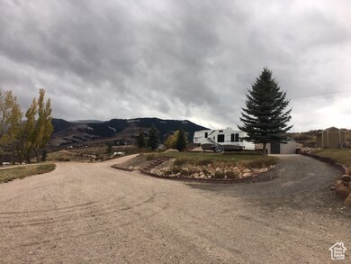 View of street with a mountain view and dirt driveway