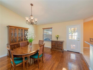 Dining room featuring a chandelier and wood-type 