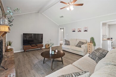 Living room with ceiling fan, vaulted ceiling with