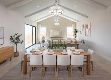 Dining area with vaulted ceiling and chandelier