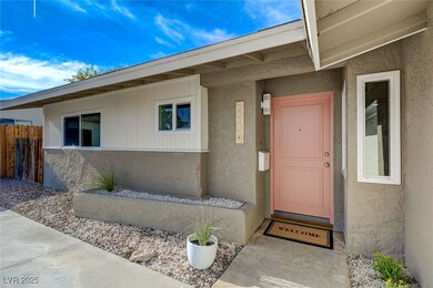 Doorway to property featuring fence and stucco sid