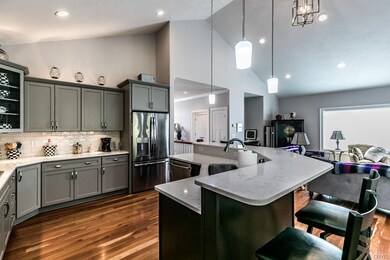 Kitchen open to family room with vaulted ceilings 
