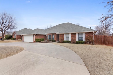 Single story home featuring a garage, concrete dri