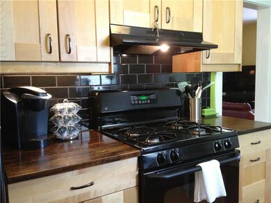 Kitchen. Cool black subway tile goes up to ceiling