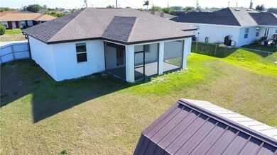 Rear view of house with a shingled roof, a fenced 