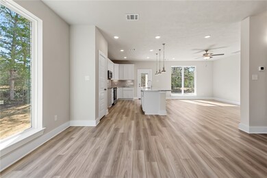 Kitchen featuring hanging light fixtures, stainles