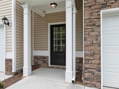 Covered front porch. Stock photos show same plan in another community, colors and finishes may vary.