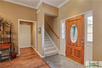 Foyer entrance with tile flooring with hardwoods t