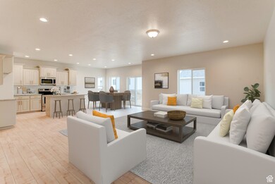 Living room with light wood-style flooring and recessed lighting