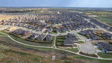 Aerial view of property and surrounding area featuring nearby suburban area