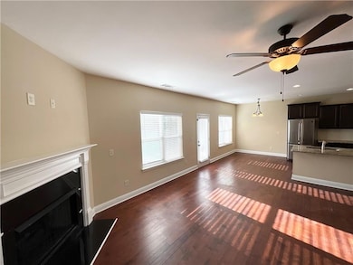 Unfurnished living room with a fireplace, dark wood-style flooring, a ceiling fan, and recessed lighting