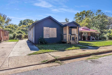Bungalow with a front yard and a porch