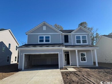 View of front of property with a garage and covere