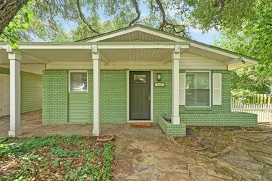View of front of house with brick siding and a po