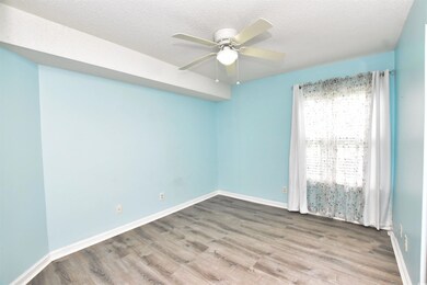 Spare room featuring a textured ceiling, wood finished floors, and ceiling fan