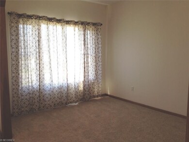 Spacious living room with large picture window.
