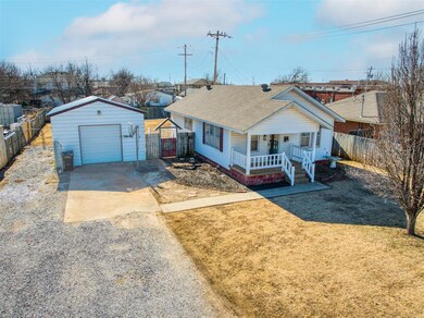 View of front facade featuring a garage, an outdoo