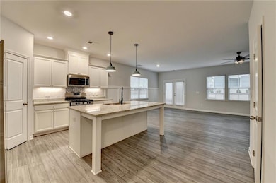 Kitchen featuring stainless steel appliances, hang