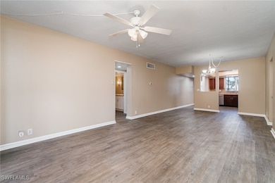 Unfurnished living room with dark hardwood / wood-