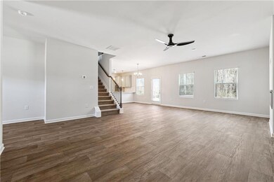 Unfurnished living room featuring visible vents, b