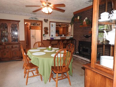 Dining room with plant shelf.