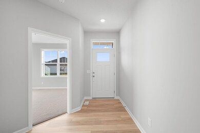 Entry way, transom window above the front door lets the light shine in!