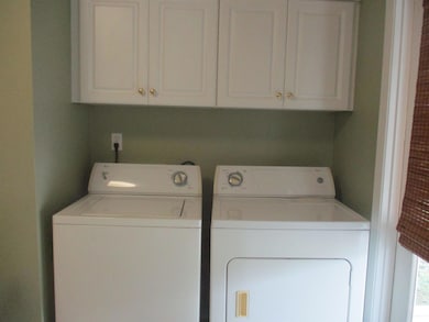Washroom with washer and clothes dryer