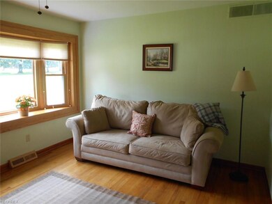 Bright and cheery living room with beautiful hardw