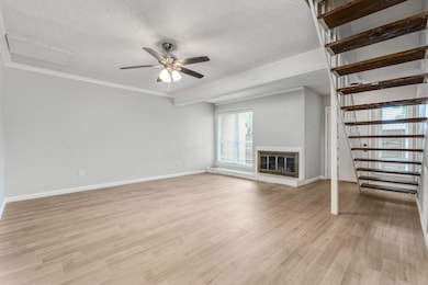 Unfurnished living room featuring a textured ceili