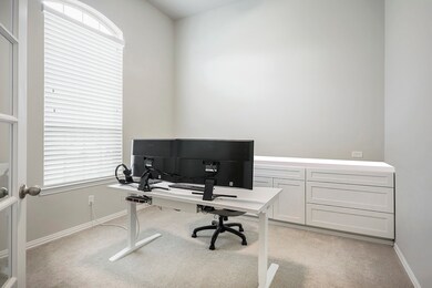 The Home Office has French doors, front yard views and built-in custom cabinetry with outlets counter high.