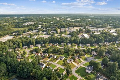 View of property location with nearby suburban area and a tree filled landscape
