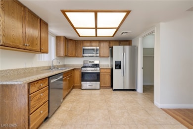 Kitchen with stainless steel appliances, brown cab