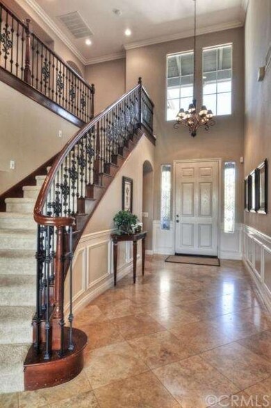 Hallway with wainscoting and iron staircase