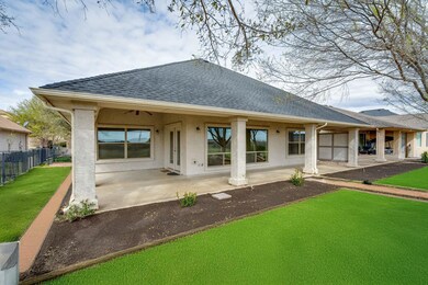 Back of house featuring a patio area, a lawn, fenc