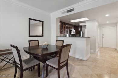 Dining space featuring ornamental molding and base