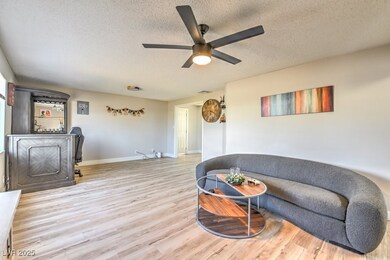 Sitting room featuring wood finished floors, a tex