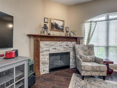 Sitting room with a fireplace and wood finished floors