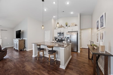 Kitchen with stainless steel appliances, dark ston