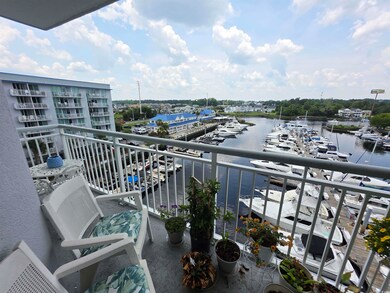 Balcony featuring view of marina and a water view
