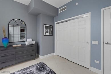 Foyer entrance with light tile patterned flooring