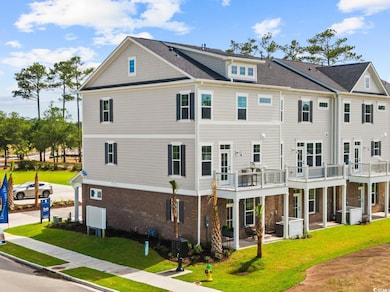 Back of house with a yard and brick siding