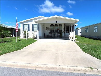 View of front of home featuring a front yard and concrete driveway