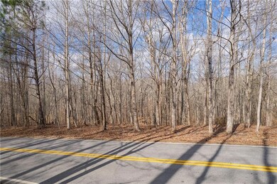 View of asphalt road featuring a forest view