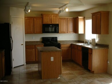Kitchen w/ Black Appliances Inc. Refrig.