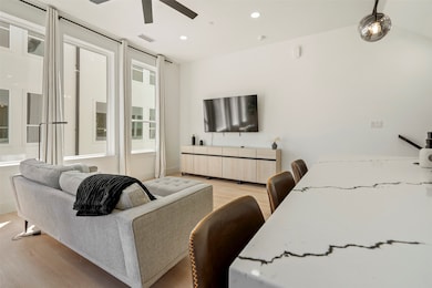 Living area with recessed lighting, light wood-style floors, visible vents, and ceiling fan