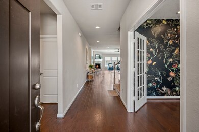 The entry foyer opens to high ceilings, providing sightlines and a harmonious transition through the home’s designated spaces.