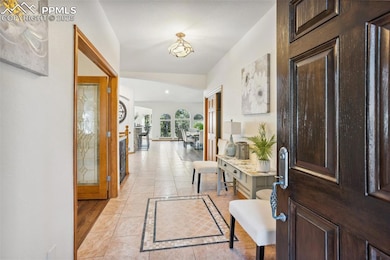 Foyer entrance featuring light tile patterned floors.