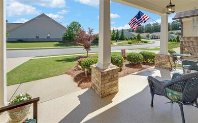 Covered porch featuring a lawn